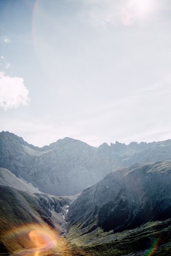 photo of valley near gray concrete mountain