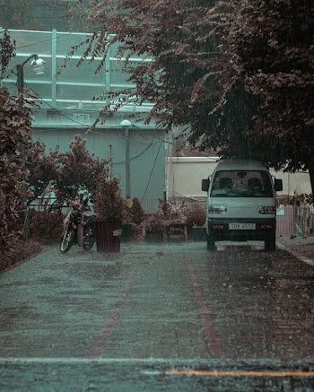 Photo of Van and Motorcycle While Raining