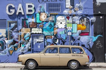 Photo of Vehicle Against a Graffiti