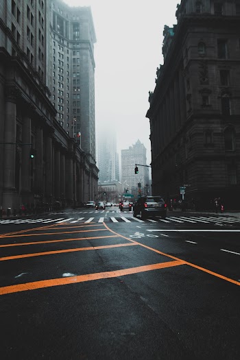 Photo of Vehicles Driving on Highway Near Buildings