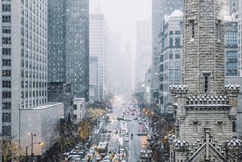 Photo of Vehicles on Road in Between Buildings