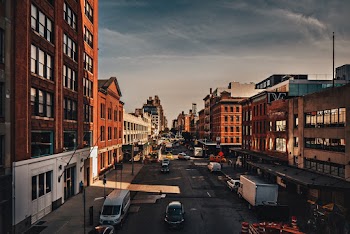 Photo of Vehicles on Road Near Buildings