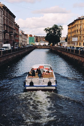 Photo of White and Blue Boat on City River