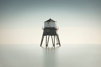 photo of white and brown house on water