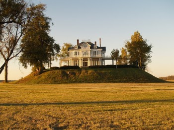 Photo of White and Gray House Near Green Field Surrounded With Trees