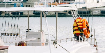 Photo of White Boat With Life Vest on Side