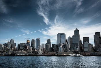 Photo of White Ferris Wheel Across City Buildings