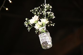 Photo of White Flowesr on Clear Glass Bottle