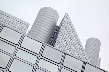 photo of white high-rise building under white sky