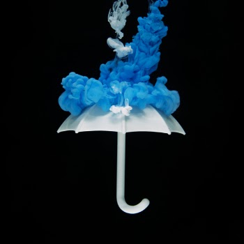 Photo of White Umbrella With Blue Smoke Illustration