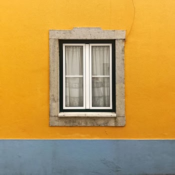 photo of white windowpane against yellow wall