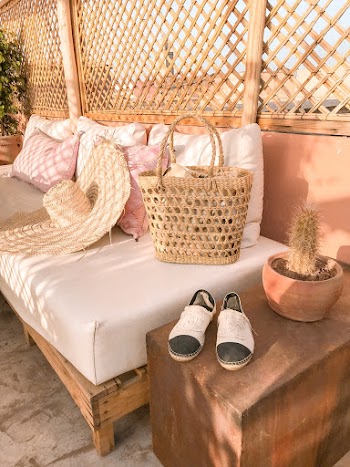 Photo Of Wicker Bag and Straw Hat On Top Of The Sofa