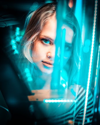 Photo of Woman's Face in Front of Neon Light