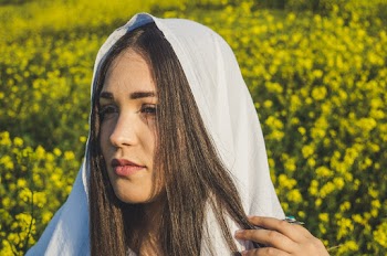 Photo of Woman's Face With White Cloth on Her Head
