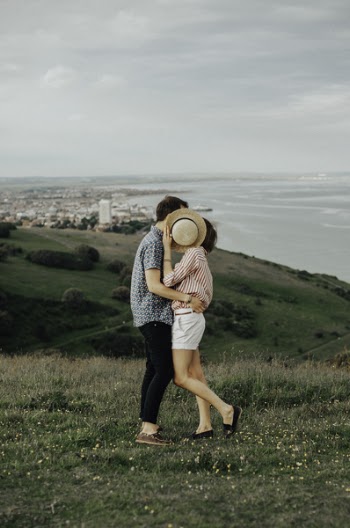 Photo of Woman and Man Hugging While Standing on Grass