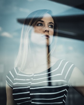 Photo of Woman Behind Glass Panel
