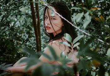 Photo of Woman Behind Green Leaves