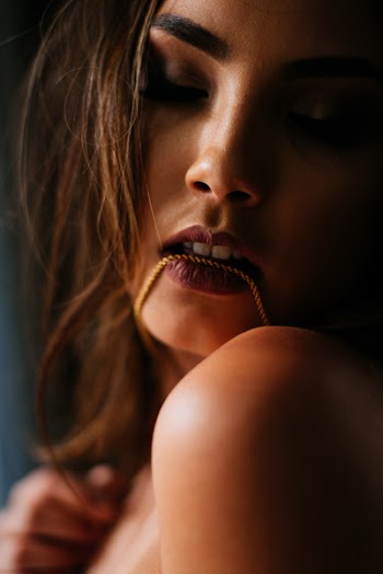Photo Of Woman Biting Her Necklace