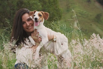 Photo of Woman Carrying A Dog