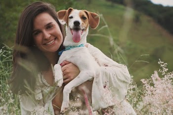 Photo of Woman Carrying A Dog