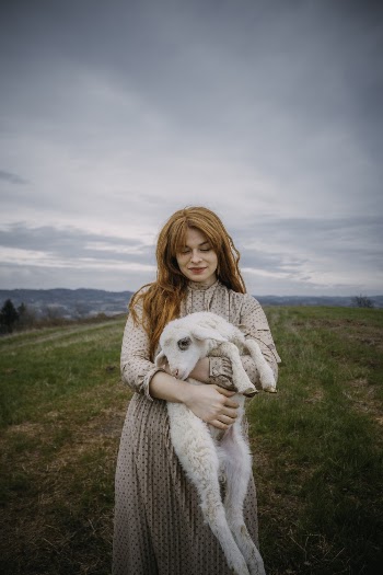 Photo Of Woman Carrying  A Lamb