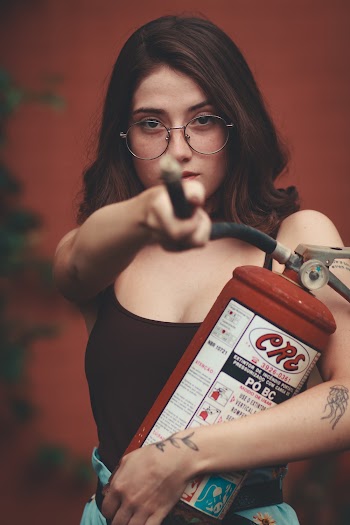 Photo of Woman Carrying Fire Extinguisher