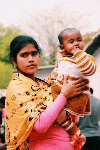 Photo of Woman Carrying Her Baby