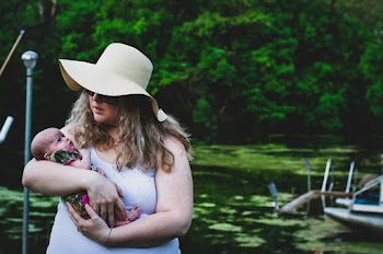 Photo of Woman Carrying Her Baby