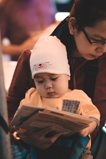 Photo Of Woman Carrying Her Child