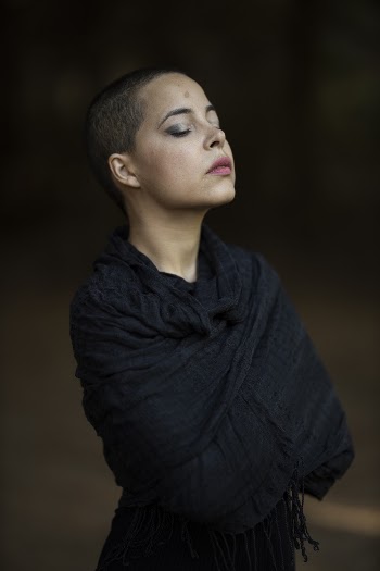 Photo of Woman Covered in Black Shawl Posing with Her Eyes Closed