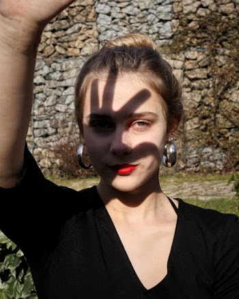 Photo of Woman Covering Her Face With Her Right Hand's Shadow