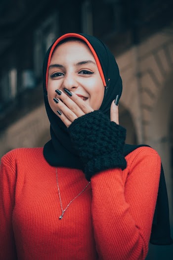 Photo of Woman Covering Her Mouth