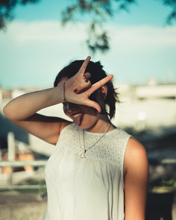 Photo of Woman Doing Hand Sign
