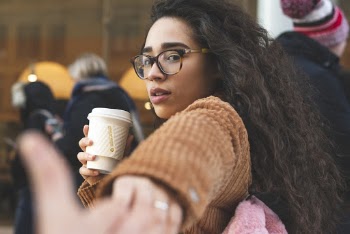 Photo of Woman Drinking Coffee Holding While Someone's Hand