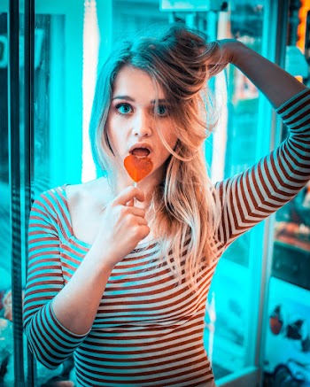 Photo of Woman Eating Lollipop
