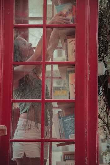 Photo Of Woman Getting Books