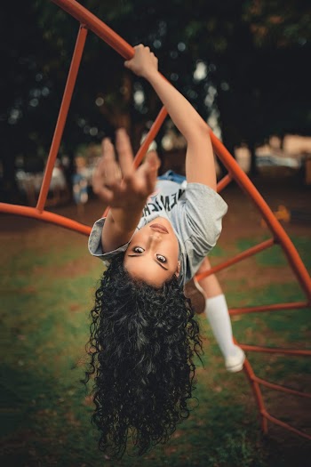 Photo Of Woman Hanging on Ladder