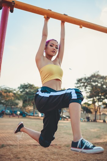Photo Of Woman Hanging On Monkey Bars