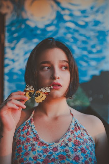 Photo of Woman Holding a Butterfly