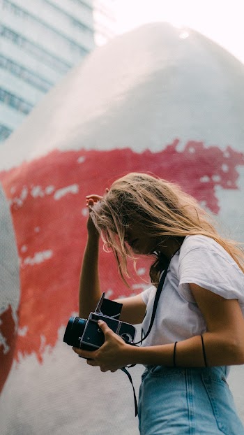 Photo of Woman Holding a Camera
