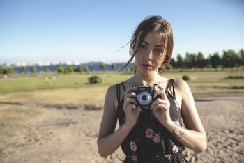 Photo of Woman Holding a Camera