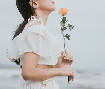 Photo Of Woman Holding A Flower