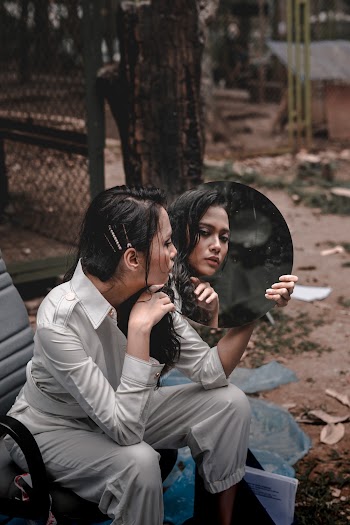 Photo of Woman Holding A Mirror