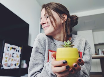 Photo Of Woman Holding A Plant