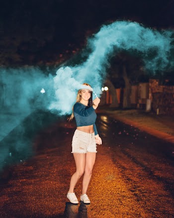 Photo of Woman Holding a Smoke Bomb