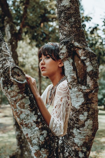 Photo Of Woman Holding A Tree