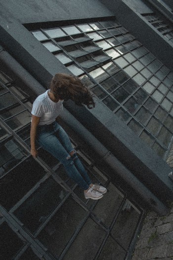 Photo of Woman Holding and Standing on Ladder