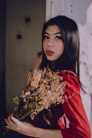 Photo Of Woman Holding Beige Flowers