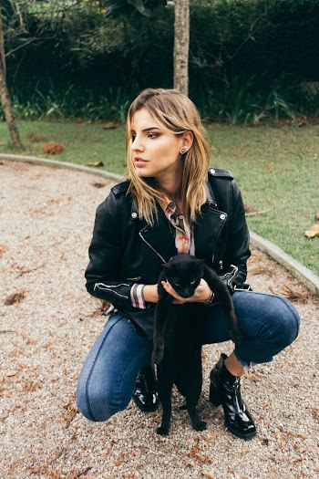Photo of Woman Holding Black Cat