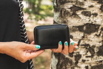 Photo of Woman Holding Black Leather Wallet